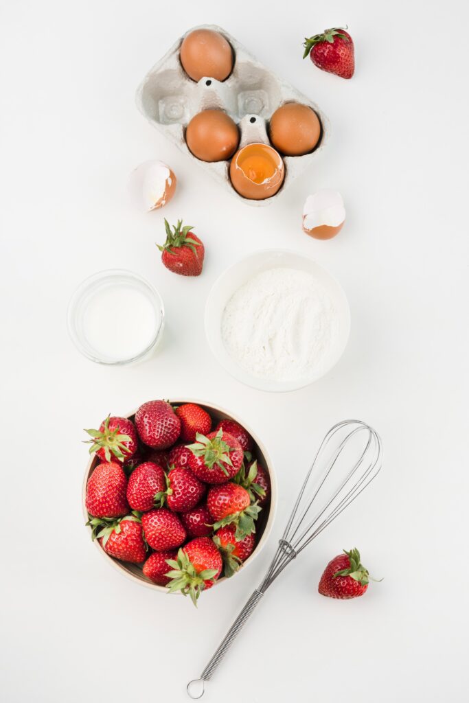 top-view-whisk-with-strawberries-eggs